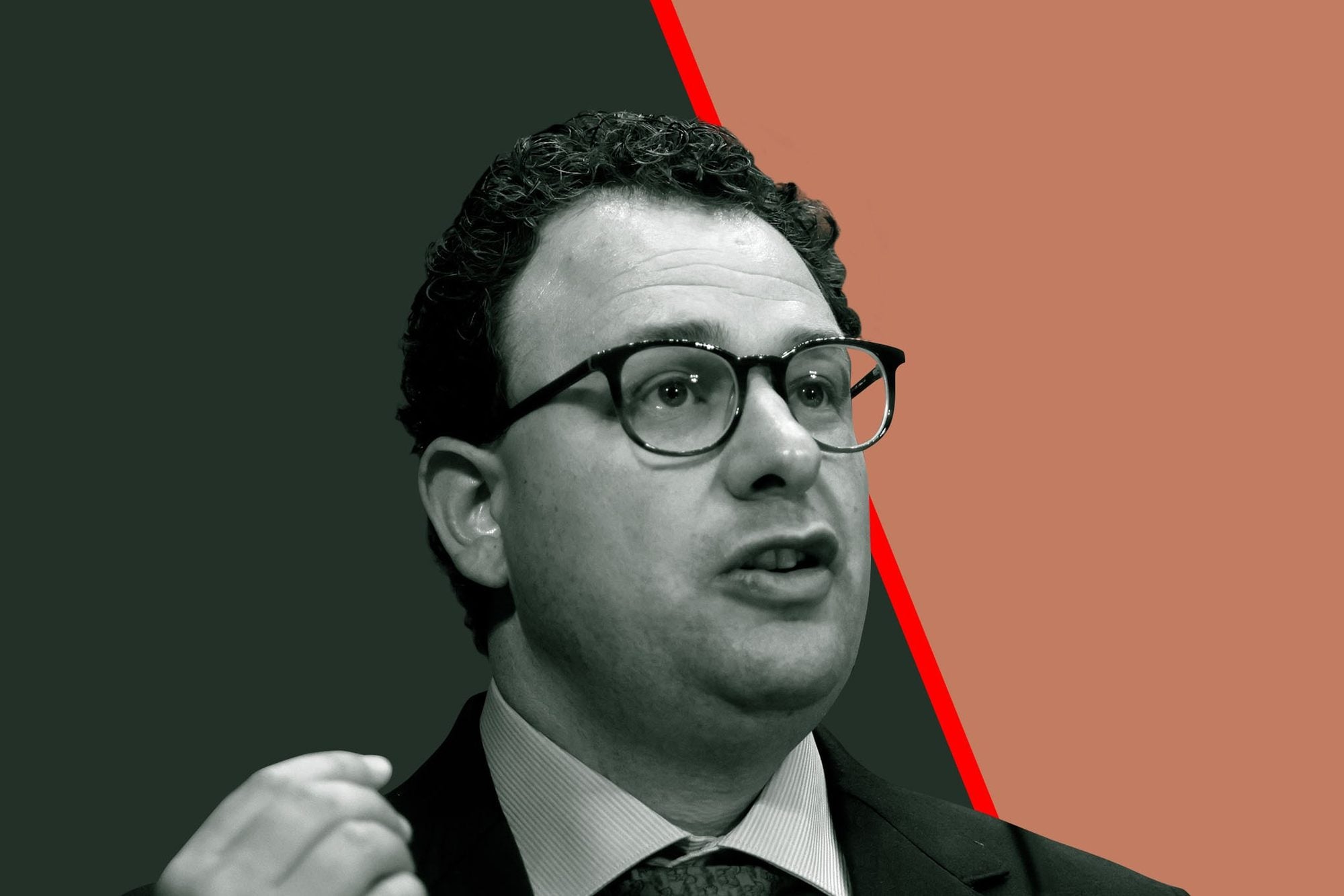Person wearing glasses and business attire speaking in front of split background with red accent line