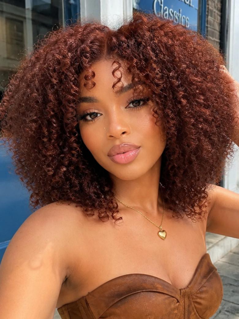 Woman with voluminous reddish-brown curly wig and side-swept bangs wearing a brown strapless top