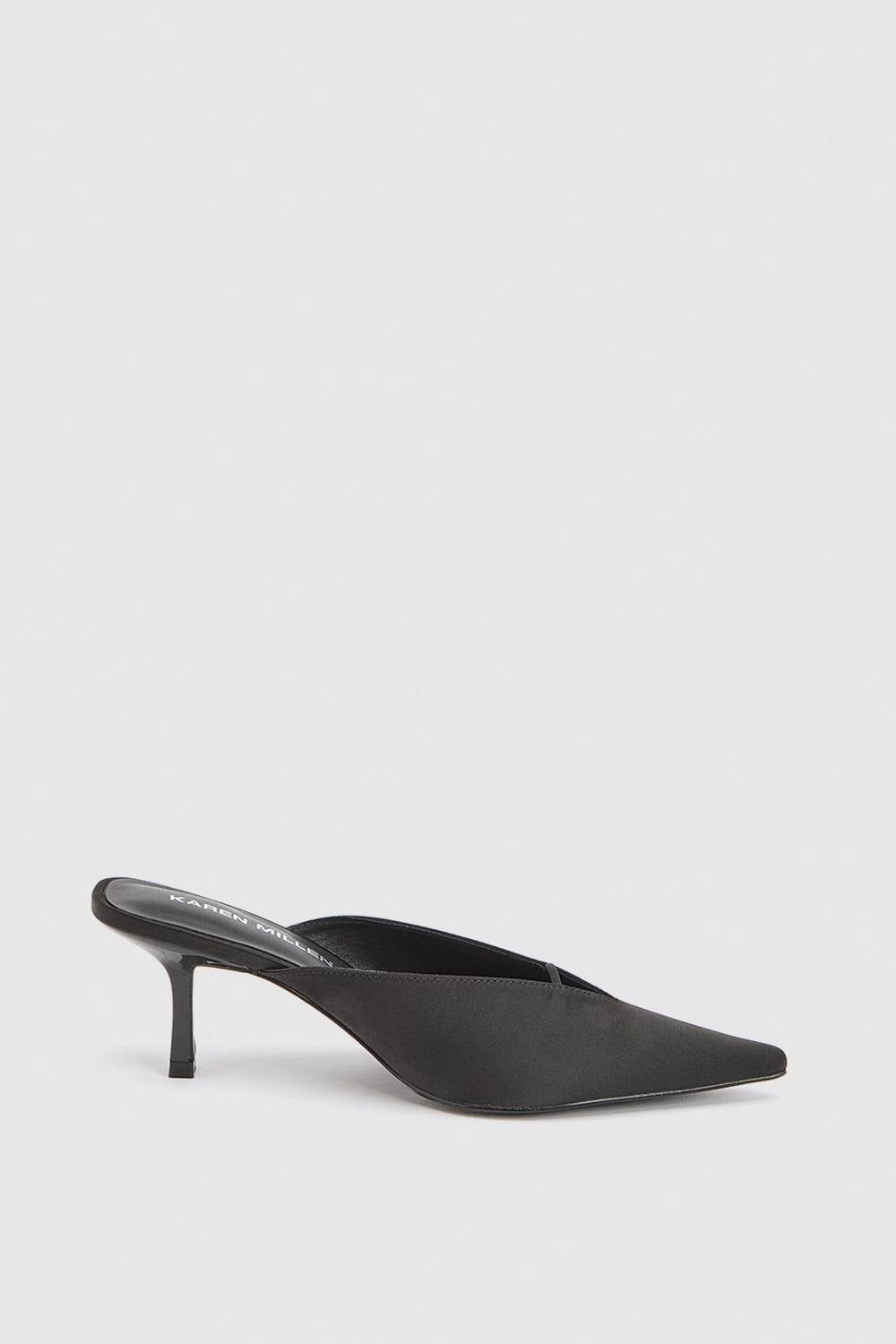 Black pointed-toe mule with slim heel on white background