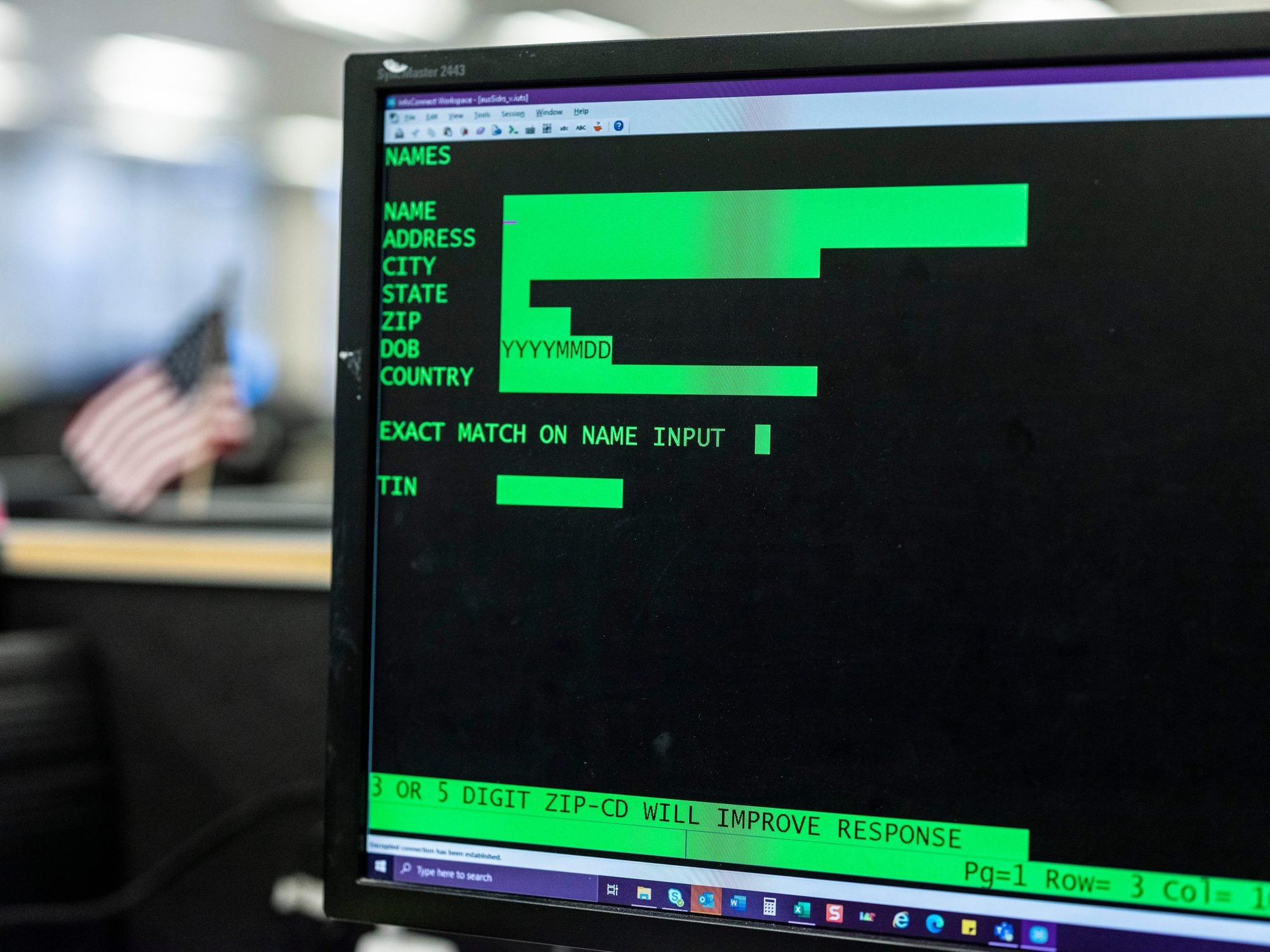 Computer monitor showing green text database interface with fields for names, addresses, and ZIP codes