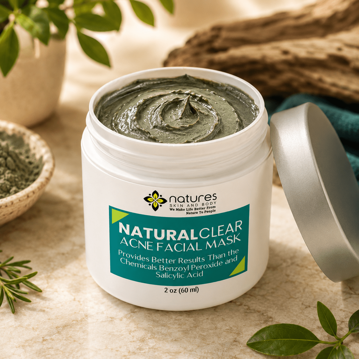 Jar of green acne facial mask with silver lid surrounded by natural elements like branches and green leaves