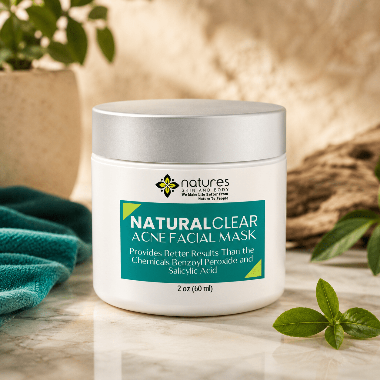 White jar with silver lid containing green acne facial mask displayed on marble surface with plants and cloth